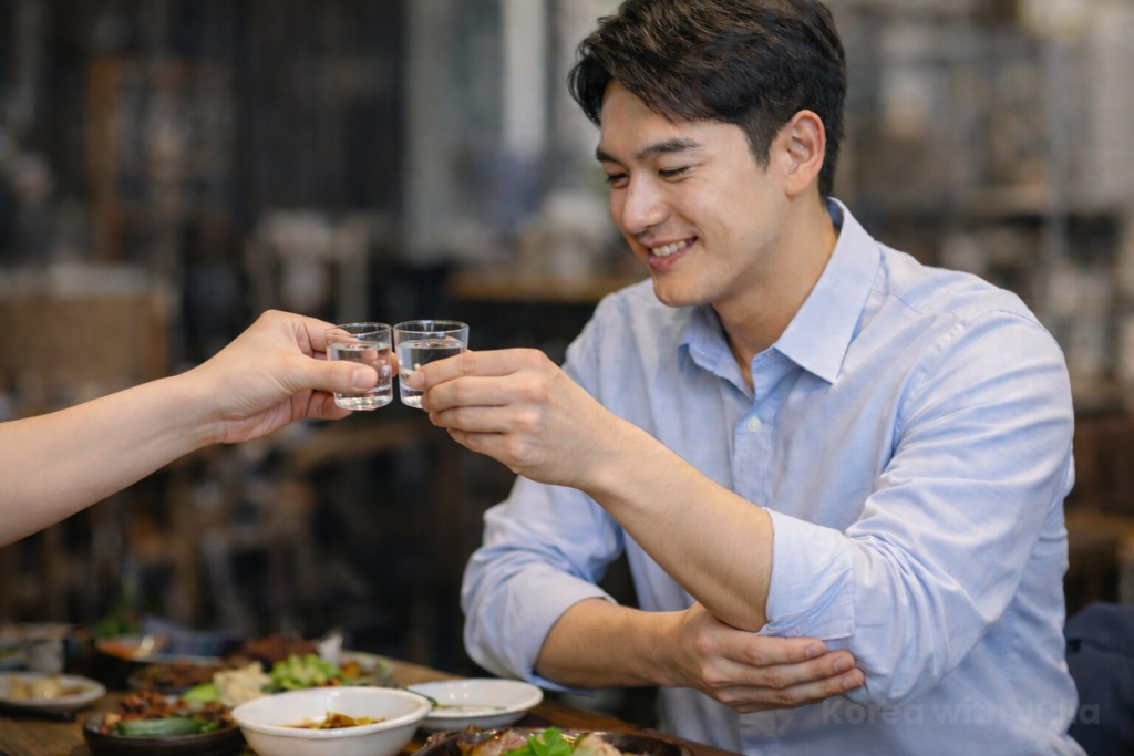 A Korean man toasting respectfully by supporting his right arm with his left hand